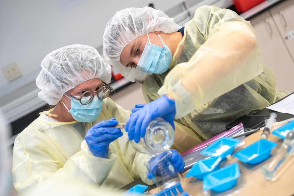 Two Pharmacy students in a lab with equipment