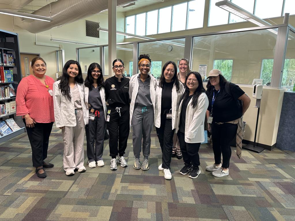 Student pharmacists after providing health screenings at a local library