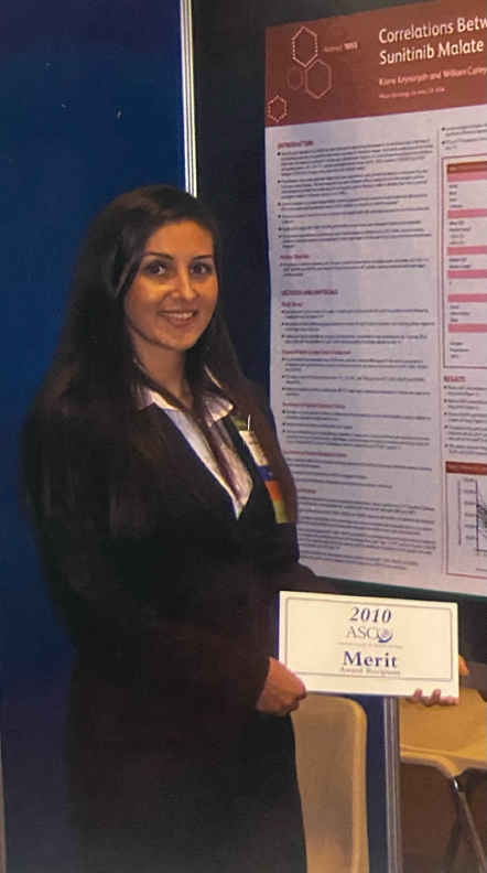 Keyvanjah stands in front of her award-winning ASCO poster 